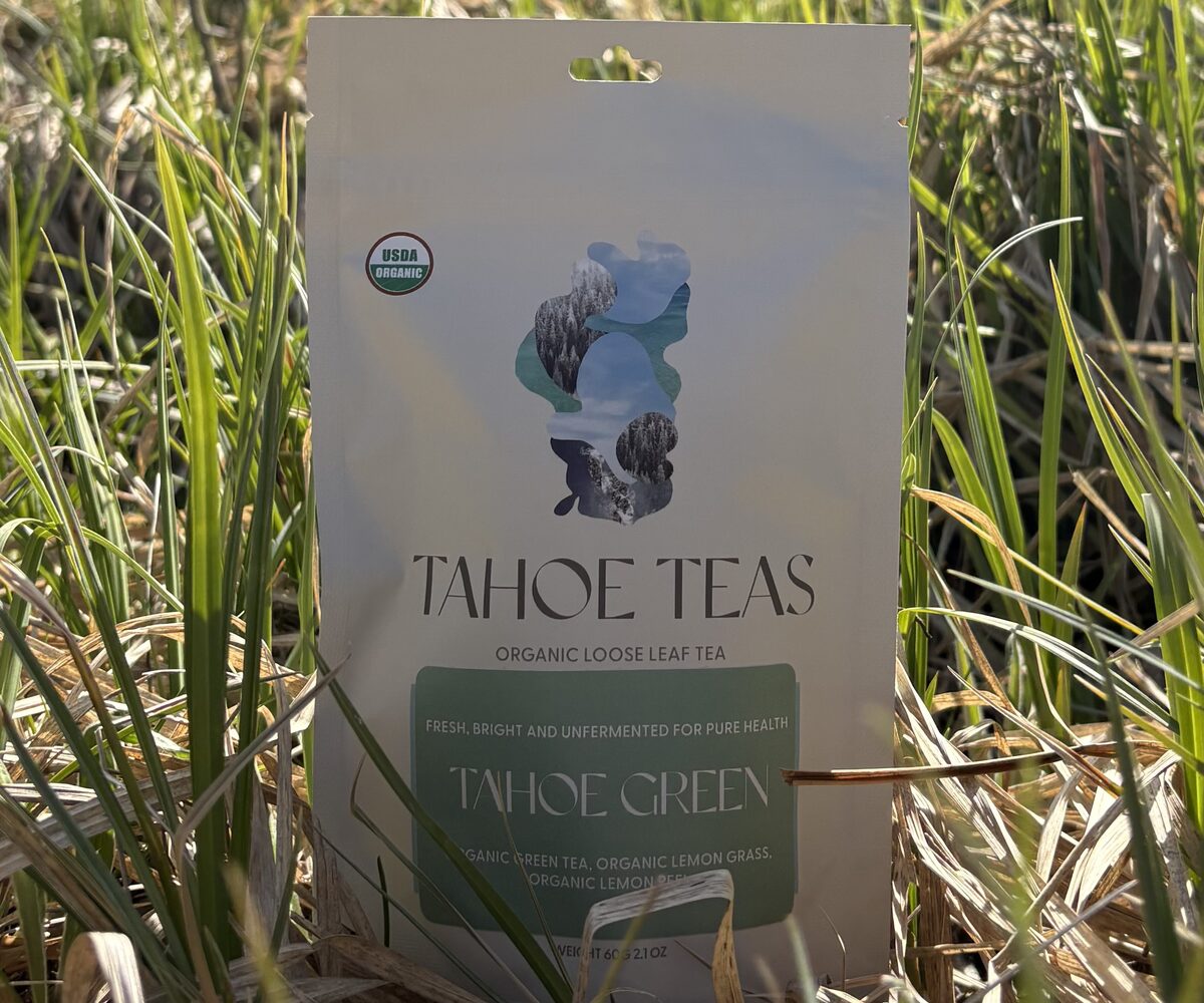 A pouch of Tahoe Green standing in spring meadow grass in an aspen grove