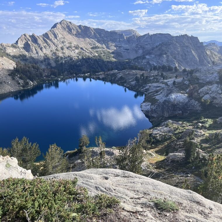 A deep blue alpine lake held in white granite below the Sierra crest