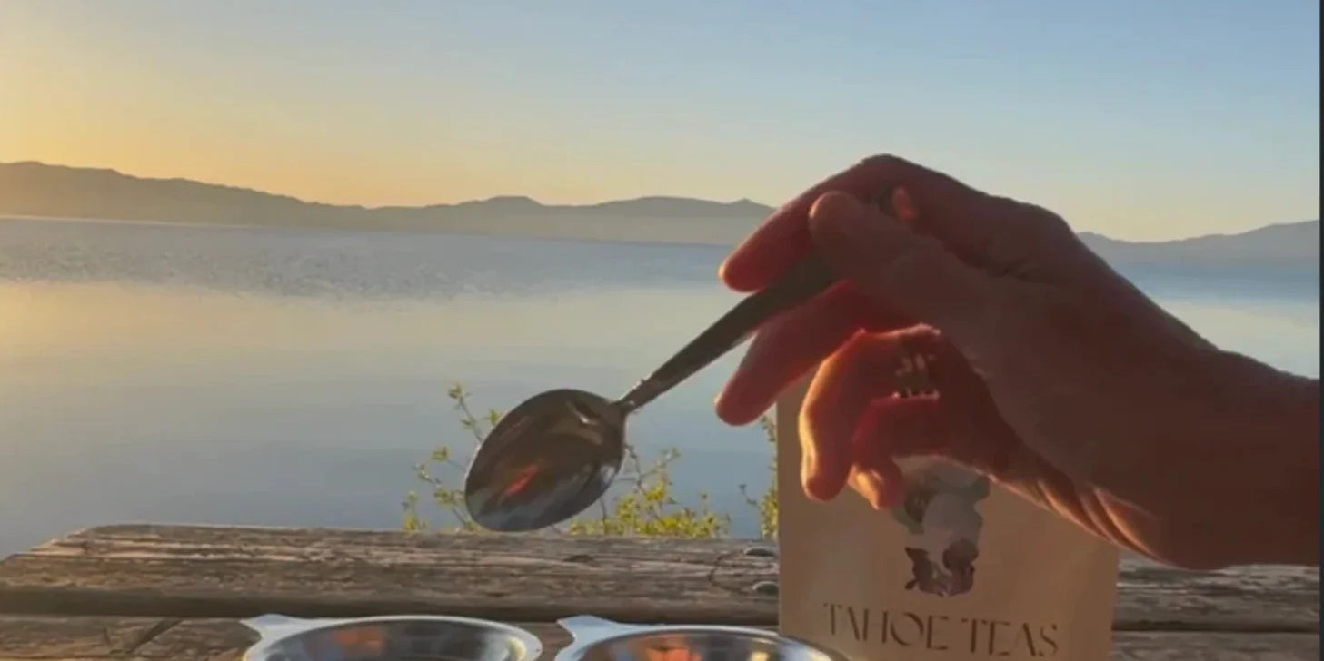 Spooning Tahoe Green tea into glass mugs over Lake Tahoe